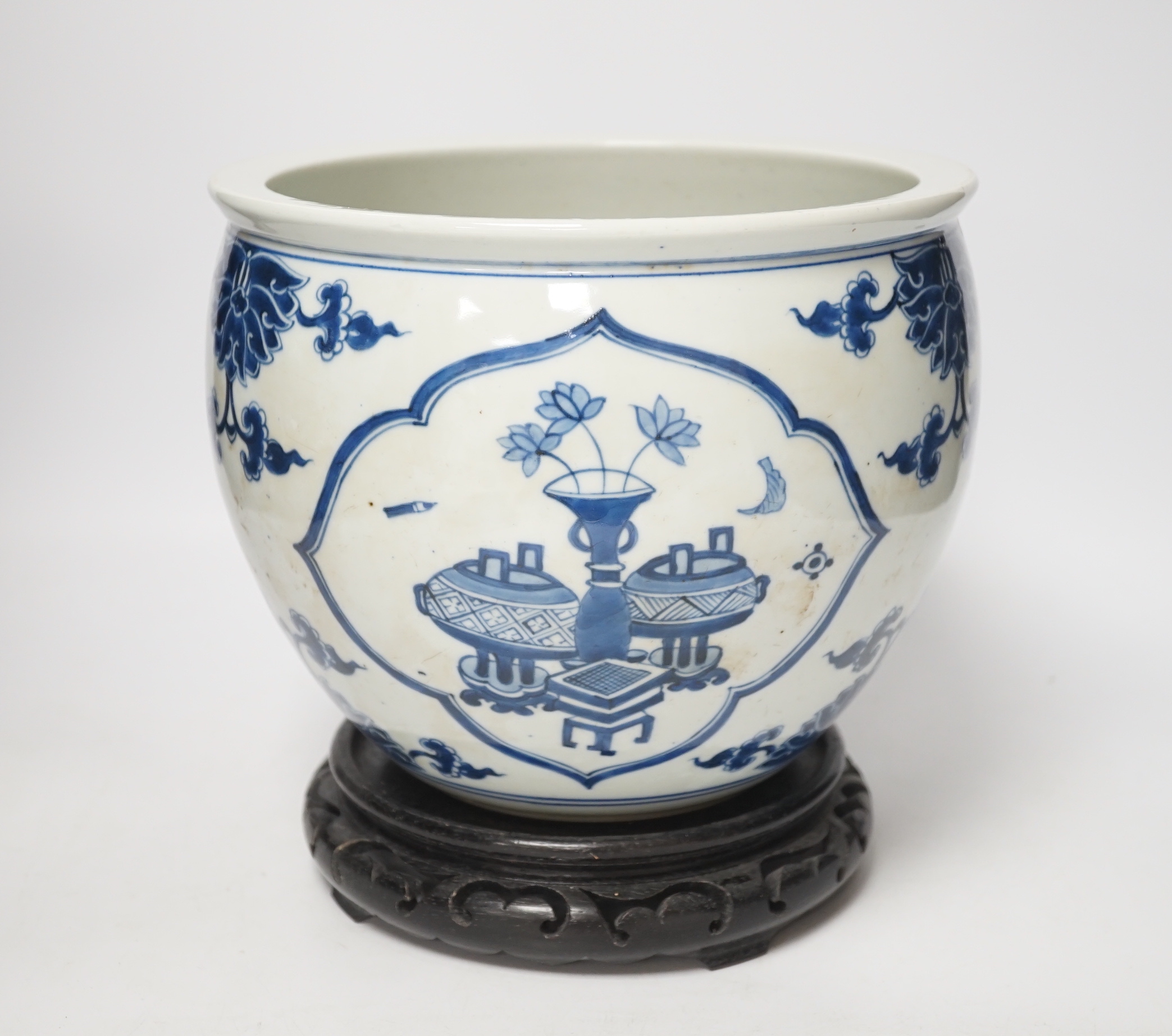 A Chinese blue and white jardiniere and hardwood stand, total height 23cm